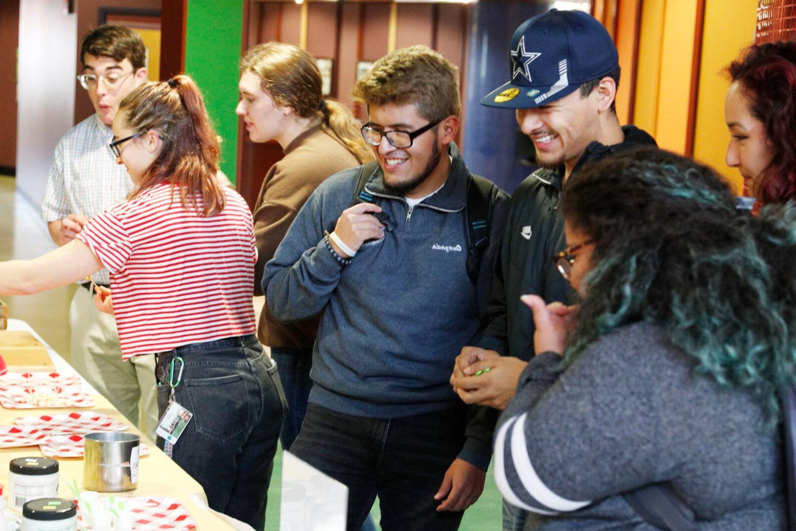 Students enjoy samples from local vendors at a farmers market-themed dinner.